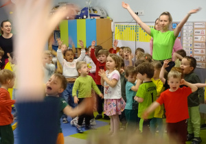 Wspólne zabawy przedszkolaków na dużej sali.