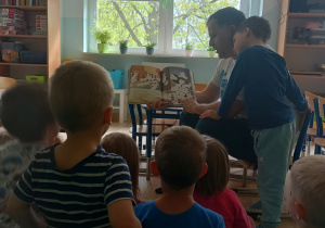 Dzieci słuchają książki czytanej przez rodzica