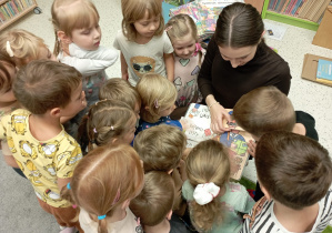 Dzieci oglądają książkę.