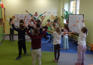 Dzieci wykonują ćwiczenia gimnastyczne