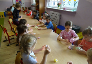 dzieci nawijają kordonek na baloniki